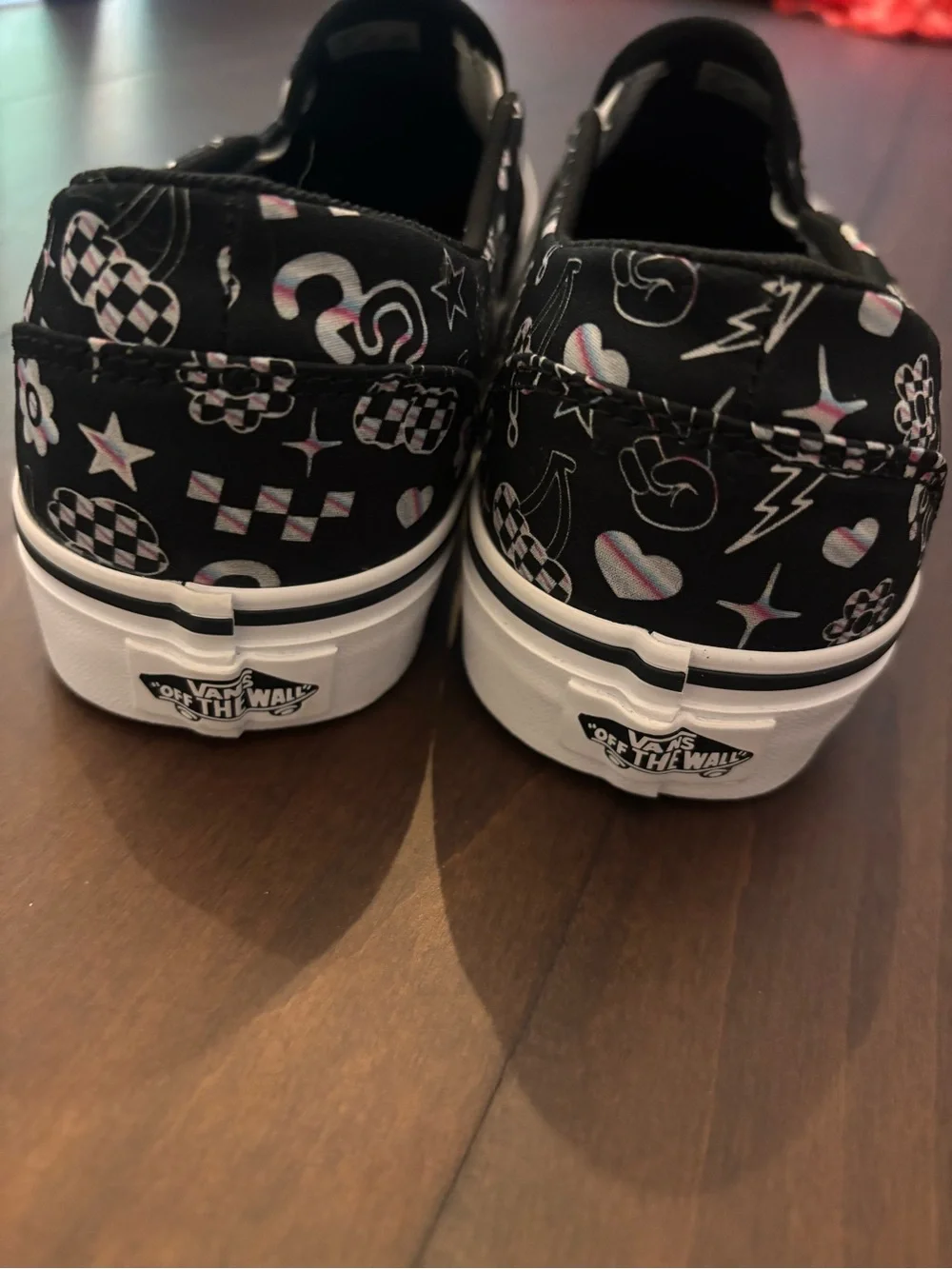 Vans Women’s Black Slip-On Sneakers with Multicolor Icon Accents